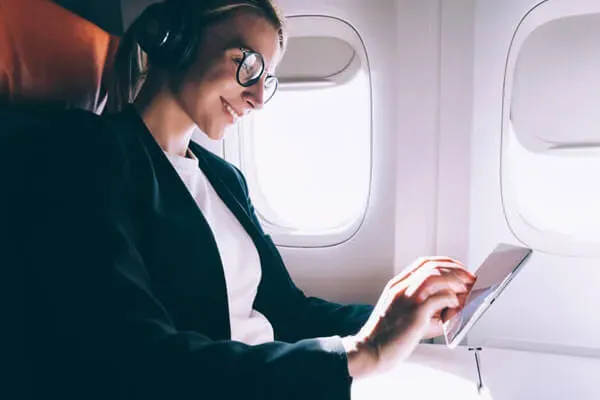 Woman looking at tablet on plane