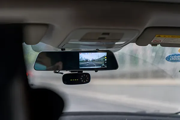 Shot of rear-view mirror with camera inside of a car