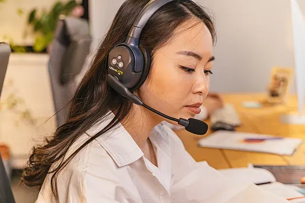 Woman looking down with headset on