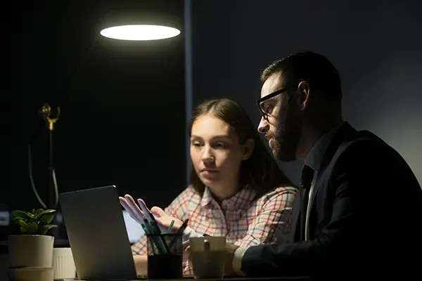 Man and woman looking at laptop screen