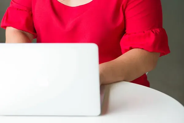 Woman using a laptop at a desk