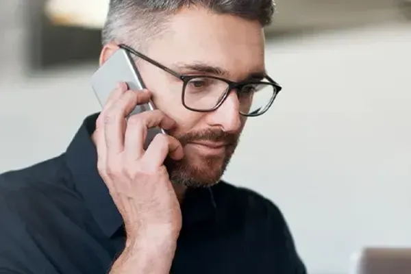 Man with glasses on phone call